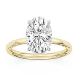 Yellow gold engagement ring featuring an oval center diamond with pavé diamond halo and band.