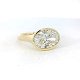 Yellow gold engagement ring featuring an oval diamond center stone 