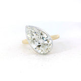 Yellow gold engagement ring featuring an oval-cut center diamond 