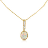 Yellow gold pendant necklace with round diamond charm on a delicate chain.