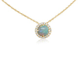 Yellow gold necklace featuring a round green gemstone pendant with diamond halo accents