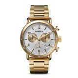 Gold-tone luxury wristwatch featuring diamond bezel, round dial, and polished link bracelet.