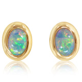 Oval opal stud earrings with diamond halo accents in yellow gold.