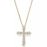 Yellow gold cross pendant necklace featuring pavé diamond accents.