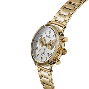 Side view of a gold-tone diamond wristwatch with pavé-set accents and textured bracelet.