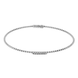 White gold diamond tennis bracelet featuring round brilliant-cut diamonds in a classic line setting.